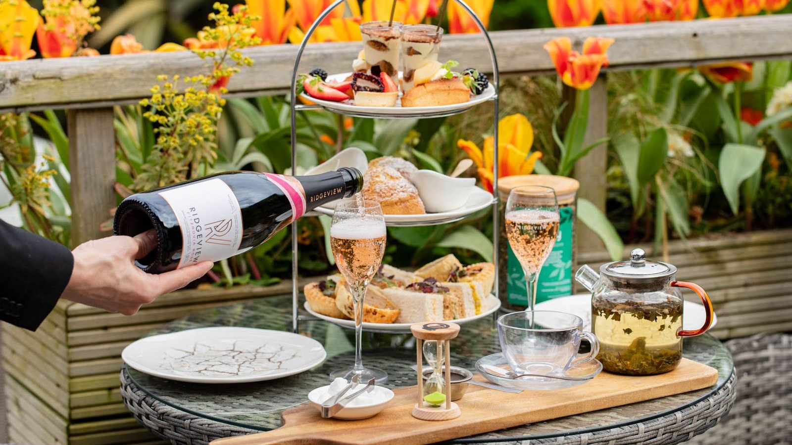 Sussex sparkling wine being poured alongside afternoon tea at Tottington Manor