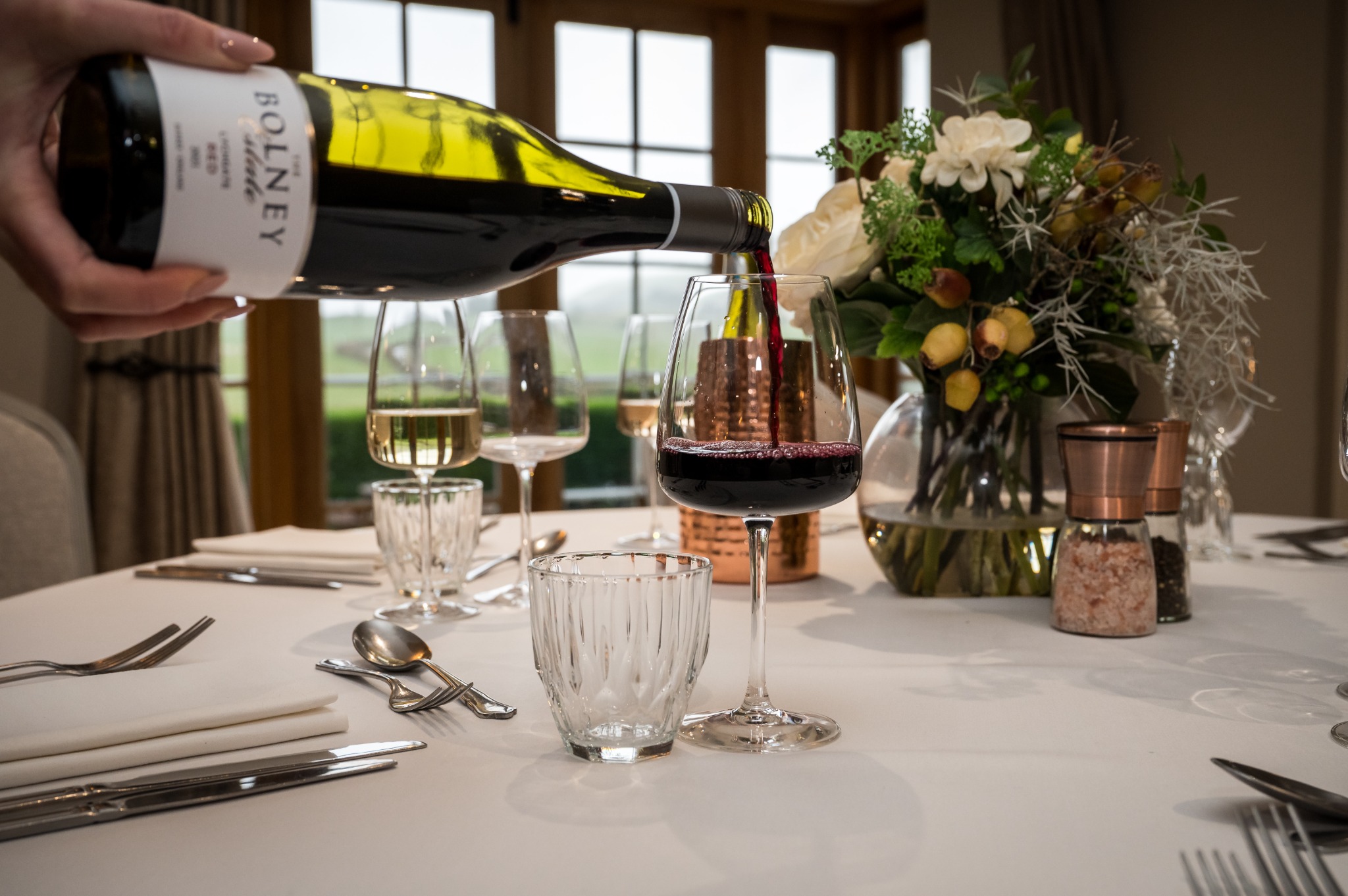 Red wine being poured for private dining at Tottington Manor