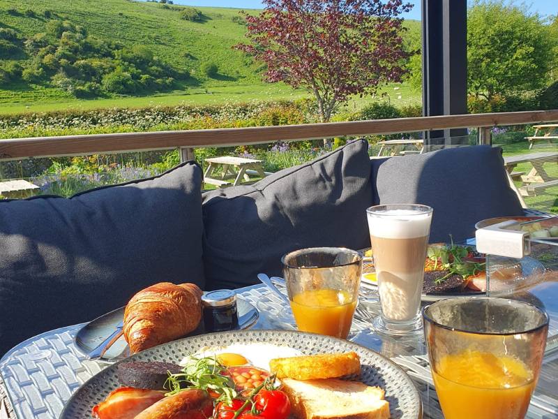 Enjoy a breakfast made from local ingredients outside in the pergola at Tottington Manor in West Sussex