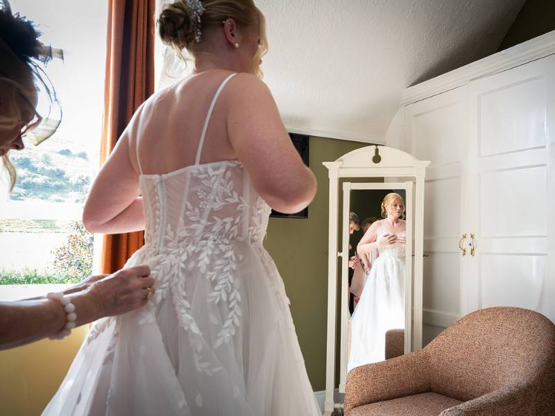 Putting the finishing touches to your wedding dress in the Getting Ready Room at Tottington Manor